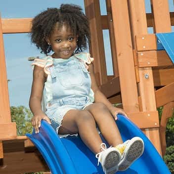Child on playset slide