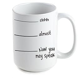 a coffee mug with lines on it that have text reading shh, almost, now you may speak