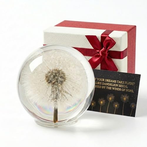 a crystal glass paperweight with a real dandelion sealed inside, sitting on a desk