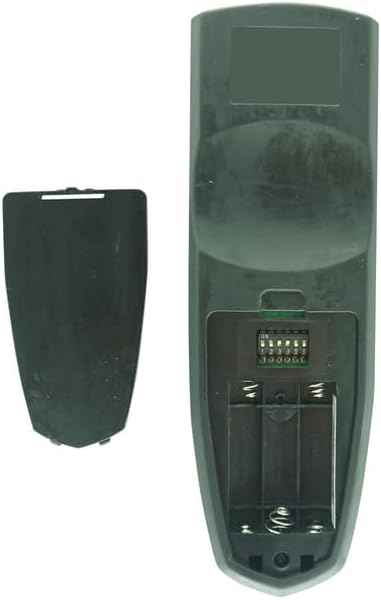 Whakamuri view of the remote control with the battery cover removed, showing a set of small dip switches.