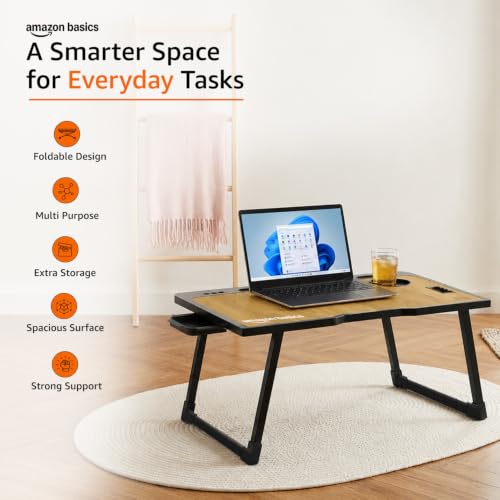 Image of Amazon Basics Engineered Wood Foldable Laptop Table with Cup and Pen Holder, Tablet and Mobile Phone Groove | Mini Drawer, Use for Writing, Bed, Breakfast (60L x 40W x 25H cm, Brown)