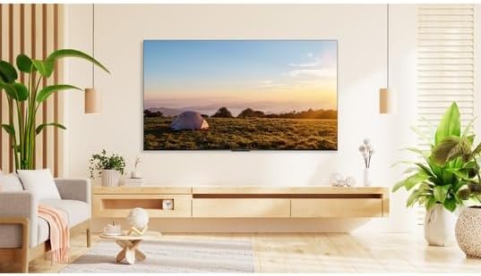 TCL 58V6B 58-inch 4K Ultra HD Smart TV mounted on a wall in a living room setting