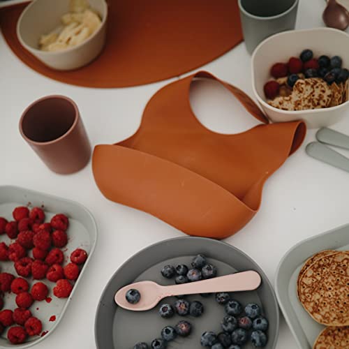 Image of mushie Silicone Baby Bib | Adjustable Fit Waterproof Bibs (Clay)