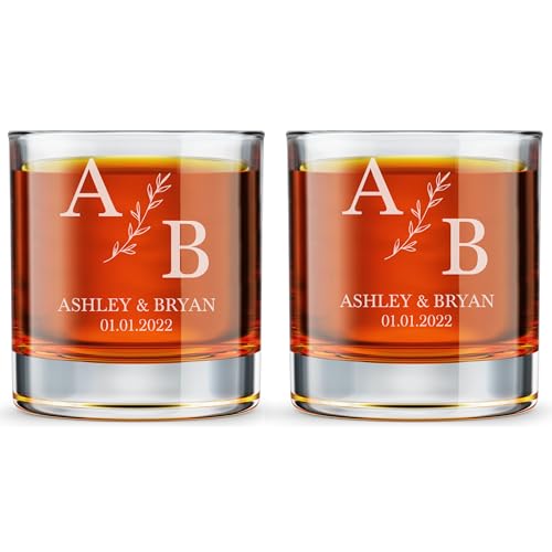 two engraved rocks glasses filled with amber liquor on a bar cart