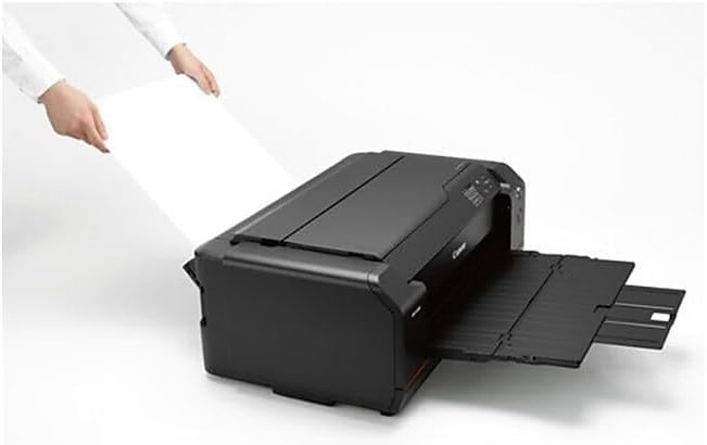 Hands loading paper into the top feeder of the Canon imagePROGRAF PRO-1000 printer