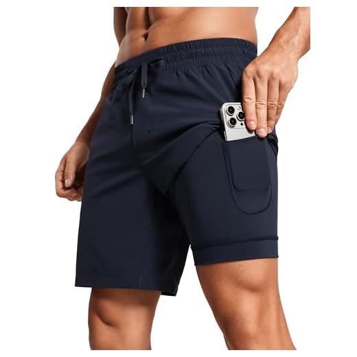 CRZ YOGA Löparshorts för män med foder snabbtorkande träning torr passform sport atletiska shorts med fickor – 7 tum, Marinblått Xsp, M
