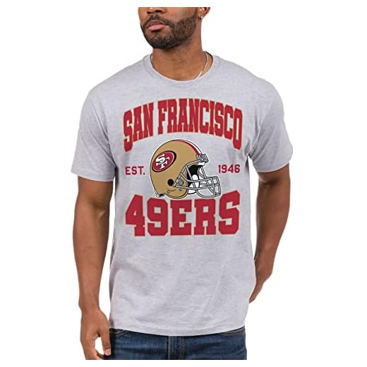 Junk Food Clothing x NFL - San Francisco 49ers - Team Helmet - Short Sleeve Football Fan Shirt for Men and Women - Size 2 X-Large
