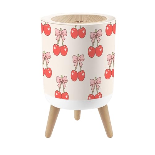 Pequeño bote de basura con tapa color rosa con moños