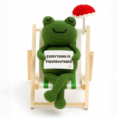 A handmade crochet frog desk companion with an oddly perfect motivational message — the kind of thing that makes a cubicle feel human.