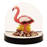 Schütteln Sie die Kugel und Sie sehen schneeweiße kleine Pünktchen, die dann ganz malerisch auf Flamingo liegen bleiben.