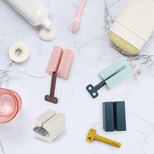 Rowphya 4 Pieces Toothpaste Dispenser Rolling Tube Toothpaste Squeezer Toothpaste Seat Holder for Bathroom Saves Toothpaste and Creams (Pink + White + Light Blue+Navy Blue)