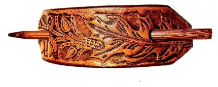 a leather-covered hair barrette with a wooden stick closure, shown in a warm brown tone