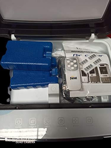 Inside view of Ferroli air cooler showing remote control, instruction manual, and ice packs