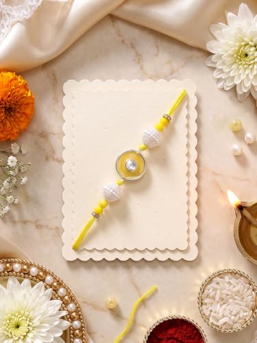 Image of Karatcart Vibrant Yellow Meena Evil Eye Design Handmade Kundan Rakhi for Brother with Roli Chawal