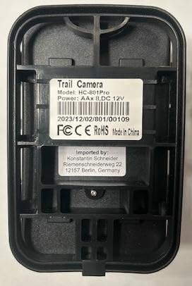 Артка view of the Suntek HC-801LTE trail camera, showing the battery compartment and product information label.