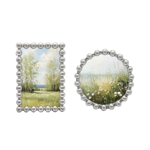 two small silver beaded picture frames on a table