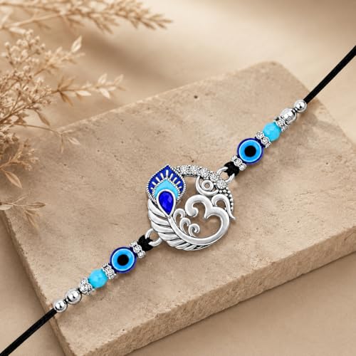 Image of Riddhika Ventures Religious Meenakari Om and Peacock Feather Rakhi With Roli Chawal And Greeting Card