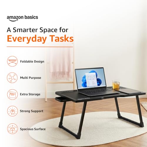 Image of Amazon Basics Engineered Wood Foldable Laptop Table with Cup and Pen Holder, Tablet and Mobile Phone Groove | Mini Drawer, Use for Writing, Bed, Breakfast (60L x 40W x 25H cm, Black)