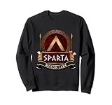 En el diseño se muestra el icónico Spartan Lambda en un escudo Aspis de Hoplite, utilizado por los lacedemonios algún tiempo después, junto con los cascos corintios y las lanzas de Dory. parte de la antigua Grecia,