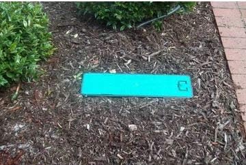 The Waterbox closed and flush with the ground in a landscaped area.