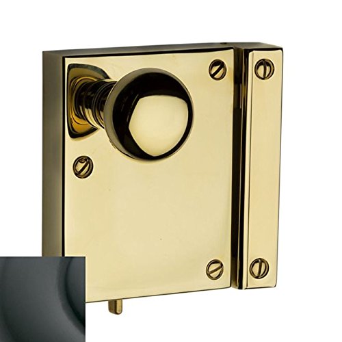 Baldwin 5604.102.R Rim Lock assembly, showing the polished brass square body, round knob, and rectangular strike plate with visible mounting screws.