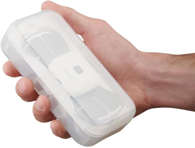A hand holding the clear storage case with the Hammacher Schlemmer TENS unit neatly placed inside.