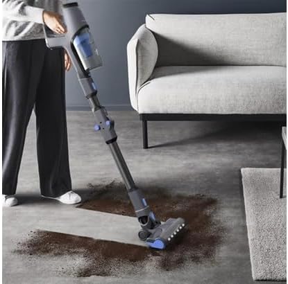 Person using Rowenta X-Pert 3.60 vacuum cleaner to clean dirt on a hard floor