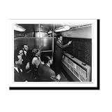 Merrill Lynch account executive chalks up current stock prices on quotation board in firm's new mobile office Vintage Wall Art Print | Classic Period Photo | Art Print Gift | 16x20