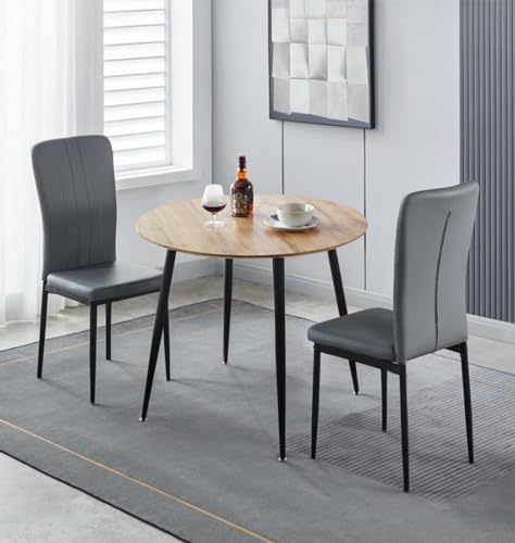 Mesa de cocina redonda con sillas grises para desayunos en pisos pequeños 2