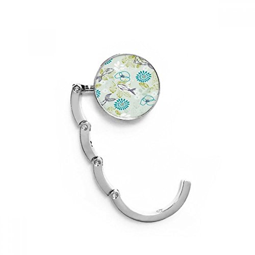 Gancho plegable del bolso para proteger tu accesorio en cualquier mesa con diseño de hojas