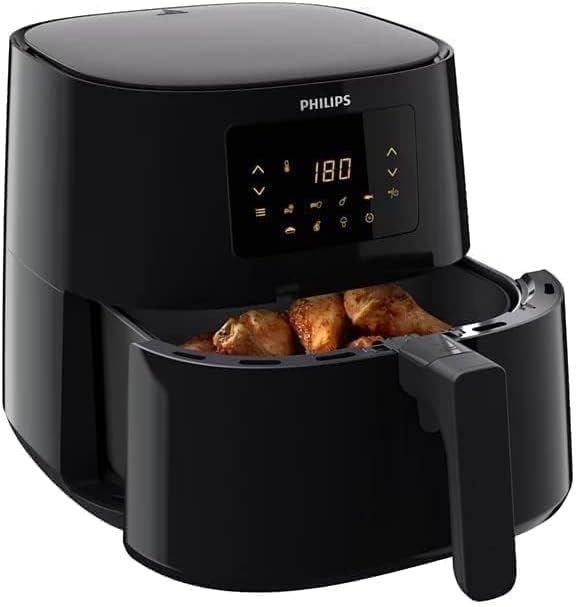 Philips Air Fryer XL with the cooking basket pulled out, containing cooked chicken pieces.