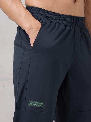 Image of TECHNOSPORT Men's Regular Fit Joggers with Zip Pockets, TS Flexi Quick Dry Stretchable Lightweight Track Pants for Gym Running and Casual Wear