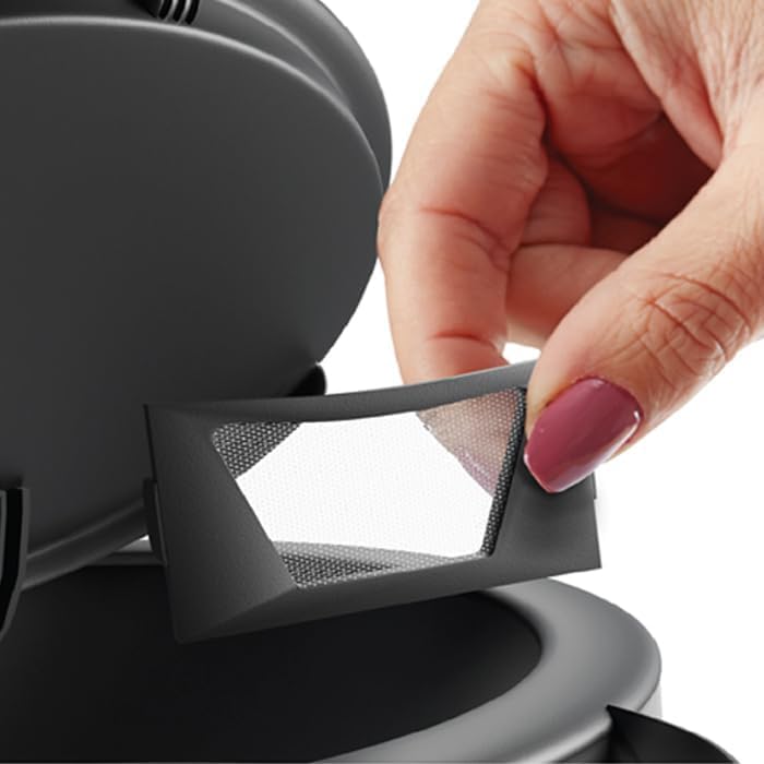 Hand removing the anti-calc filter from the Mienta glass kettle