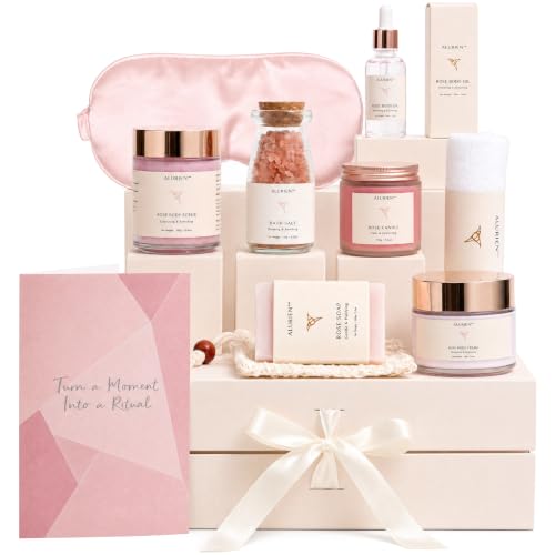 A boxed spa gift basket with rose-scented bottles and bath accessories