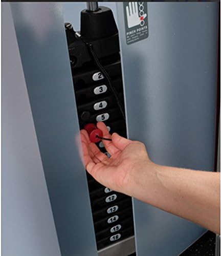 Hand adjusting weight on the selectorized weight stack