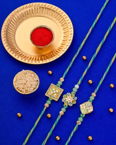 Image of Hyperfoods Rakhi for Brother with Dry Fruits Rawfruit's Handcrafted Potli Blue And Red with Thali Roli & Chawal Rakhi Gift Hamper for Brother Pack of 4 Cashew Almond Pistachios Raisins 495gm With Set of 3 Meena Rakhi