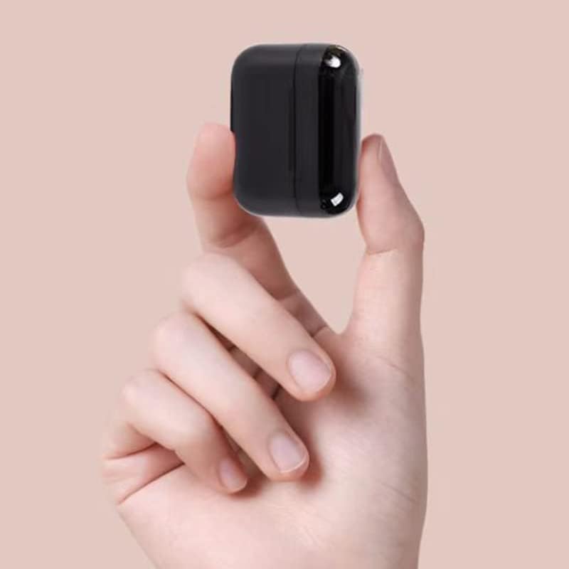 A hand holding the small black Pro 5s Mini Earbuds charging case, demonstrating its compact size.