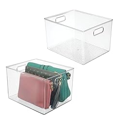 two clear open storage bins with handles, one holding purses.