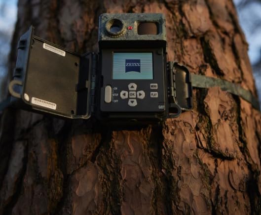 ZEISS Secacam 7 Classic trail camera mounted on a tree with its front cover open, showing the display.