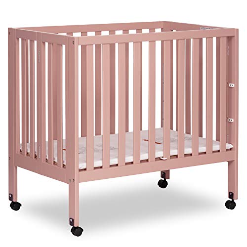 Image of Dream On Me Jett Mini Folding Baby Crib in Dusty Pink, GreenGuard Gold & BSA, Lightweight & Portable, Patented Flat Folding System for Small Spaces & Travel, 1.5” Mattress Pad, 3 Heights, Safe Wheels