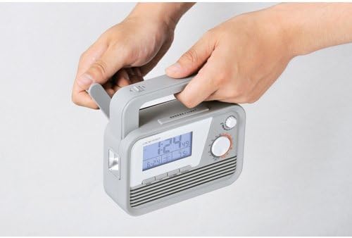 A person's hands operating the dynamo crank on the ADESSO Dynamo Radio Atomic Clock C-6020