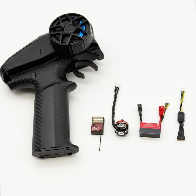 All components of the Furitek NanoModo 2026 Control System laid out: Gripor V2 transmitter, NanoPython ESC, NanoKomodo motor, and receiver.