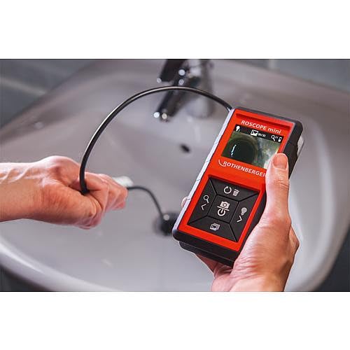 User operating Rothenberger ROSCOPE Mini to inspect a sink drain