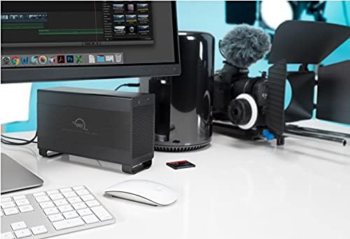 OWC Mercury Elite Pro Dual enclosure on a desk next to a computer monitor and other creative equipment
