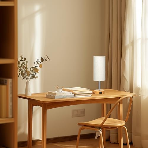 Pair of small touch table lamps casting warm gentle light in a quiet bedroom.