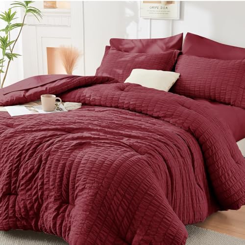 Image of HYMOKEGE Burgundy Oversized Queen Comforter Set Seersucker 7 Pieces, All Season Luxury Bed in a Bag for Bedroom, Bedding Set with Comforter, Sheets, Pillowcases & Shams