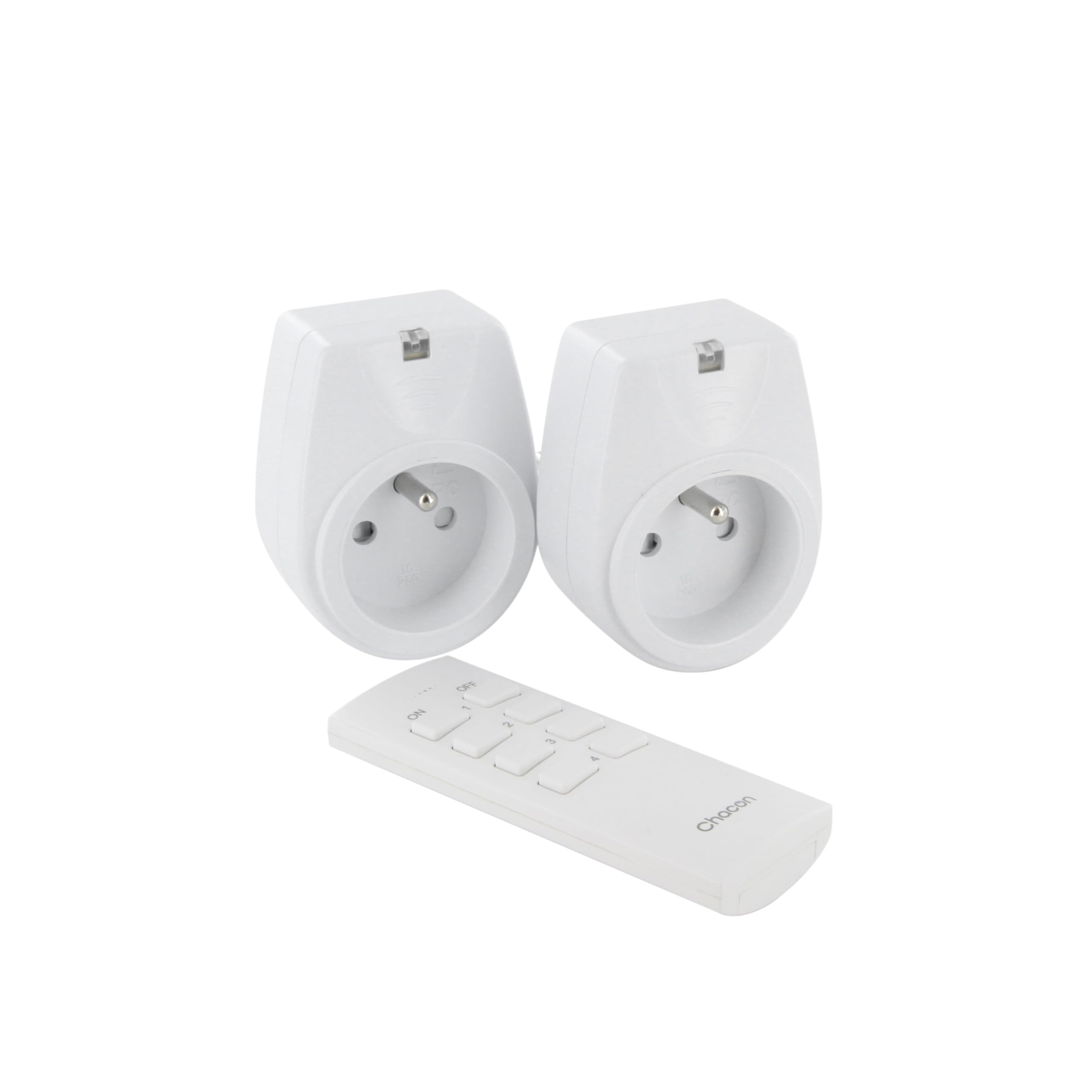 Hand holding CHACON remote control, pointing towards a lit lamp