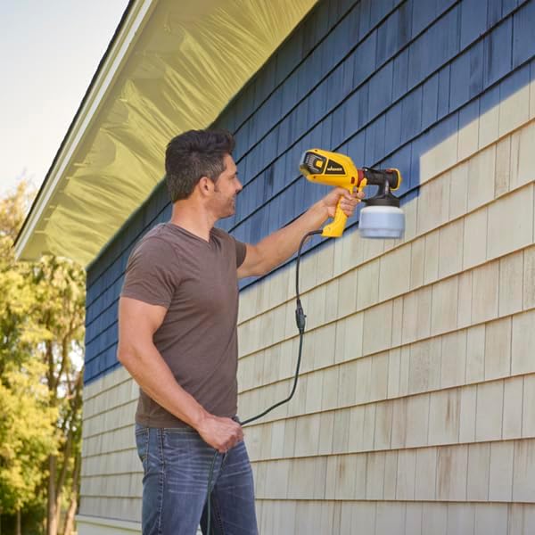 Man spraying house siding with the Wagner Control Spray QX5