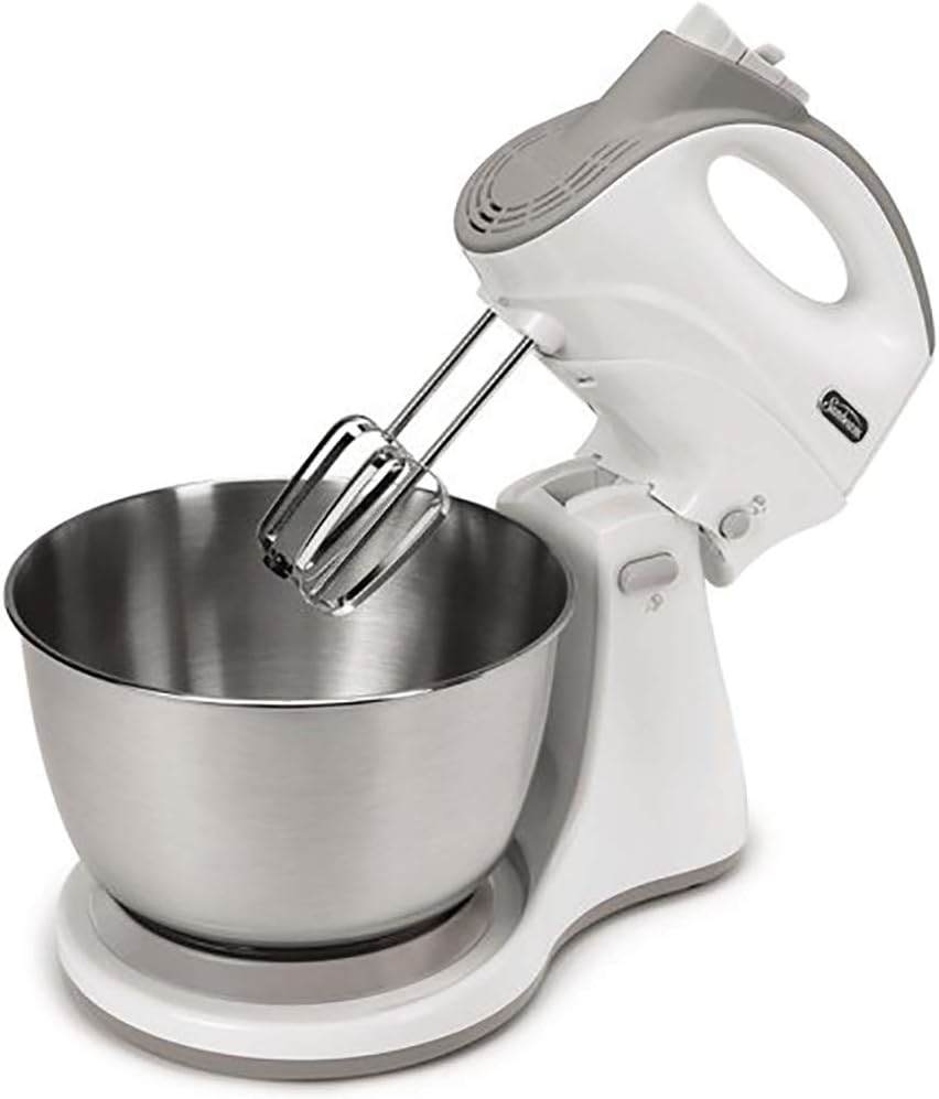 Sunbeam Mixmaster Dual Function Hand and Stand Mixer with its stainless steel bowl, chrome beaters, and dough hooks laid out.