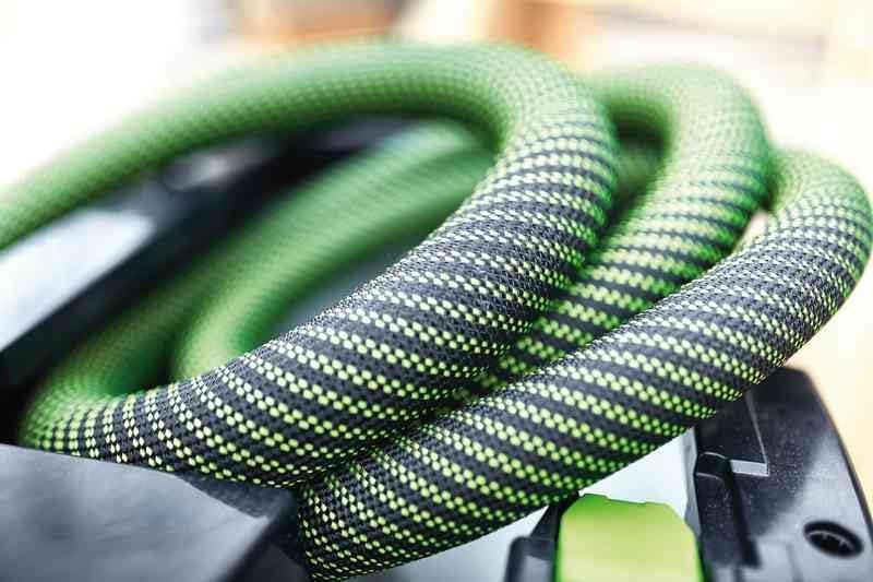 Person carrying Festool CTM 26 E AC vacuum cleaner up a ladder